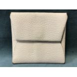 A Hermès white calfskin Bastia envelope style coin purse with snap closure.