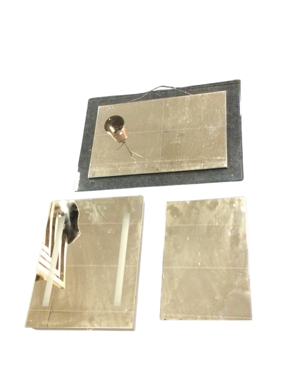 A rectangular illuminated bathroom mirror; another on a metal box mount; and a rectangular