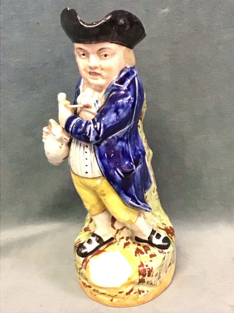 A C19th Staffordshire ceramic hearty goodfellow toby jug, the standing smiling figure holding a pipe