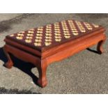 A mahogany low stool with woolwork fleur-de-lys tapestry upholstered seat above moulded rails and