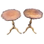 A pair of circular scalloped tray-top side tables supported on turned fluted columns with tripartite