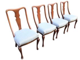 A set of four Edwardian mahogany dining chairs, the waisted backs with vase shaped splats, above