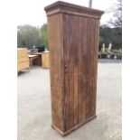 A Victorian tongue & grooved pine cupboard with hinged door enclosing shelves beneath a moulded