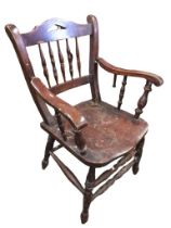 A late nineteenth century country armchair with spindles to back and shaped arms on turned