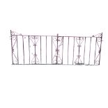 A pair of wrought iron driveway gates with scrolled decoration and spindled panels, complete with