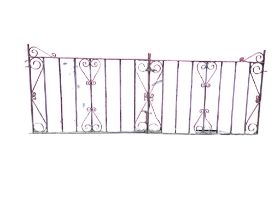 A pair of wrought iron driveway gates with scrolled decoration and spindled panels, complete with