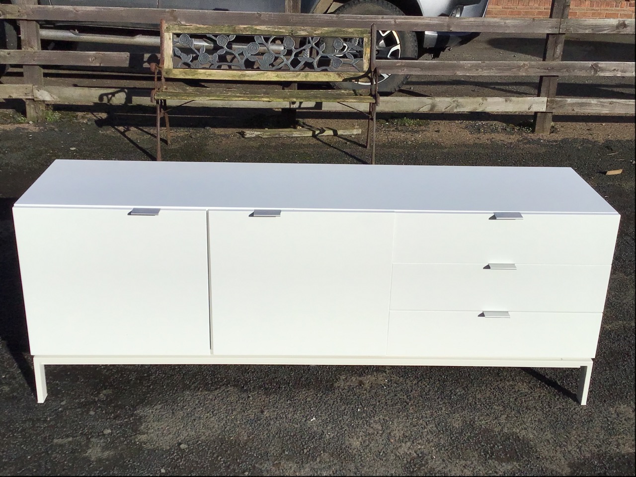 A contemporary white lacquered sideboard, the rectangular top above two cupboards and three drawers, - Image 2 of 3