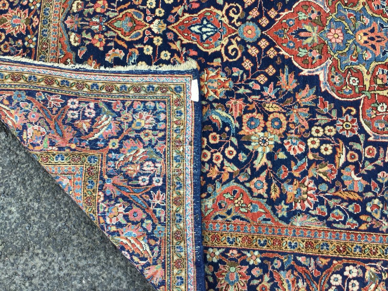 A Keshan wool rug with a quatrefoil floral medallion in a dense floral field on a blue ground, - Image 3 of 3