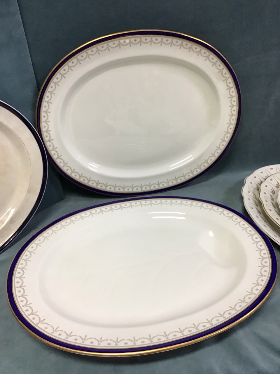 A set of three oval Adams ironstone graduated meat dishes with floral swag borders; a Booths ashet - Image 3 of 3