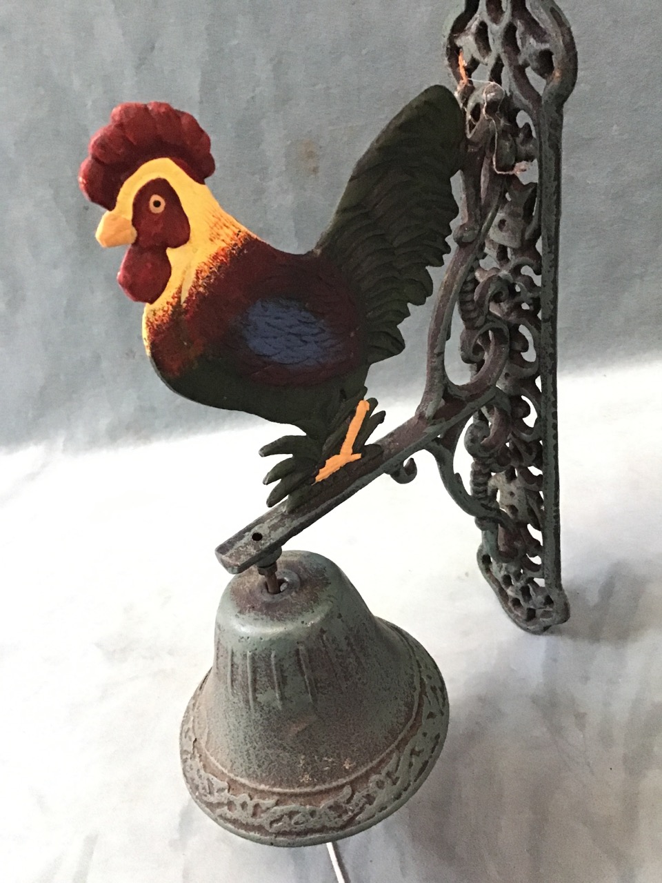 A cast iron wall bell with pierced scrolled pierced bracket surmounted by a cockerel, supporting a - Image 2 of 3