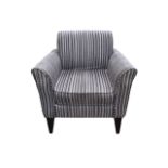 A contemporary upholstered armchair, the rectangular back above a square seat with loose cushion