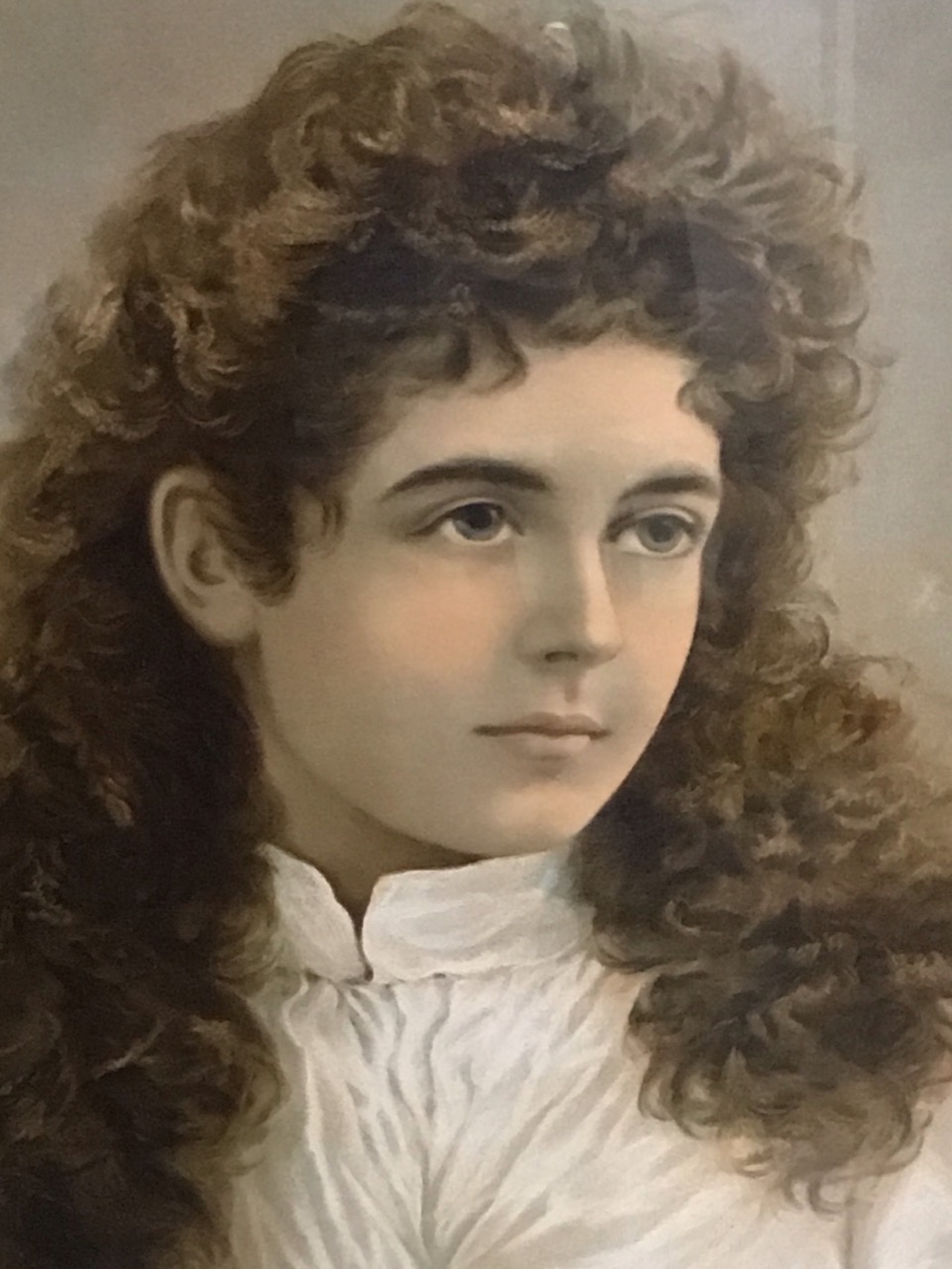 A Victorian oval chromolithograph of a young woman with curly hair, mounted & framed - 16.75in x - Image 2 of 3