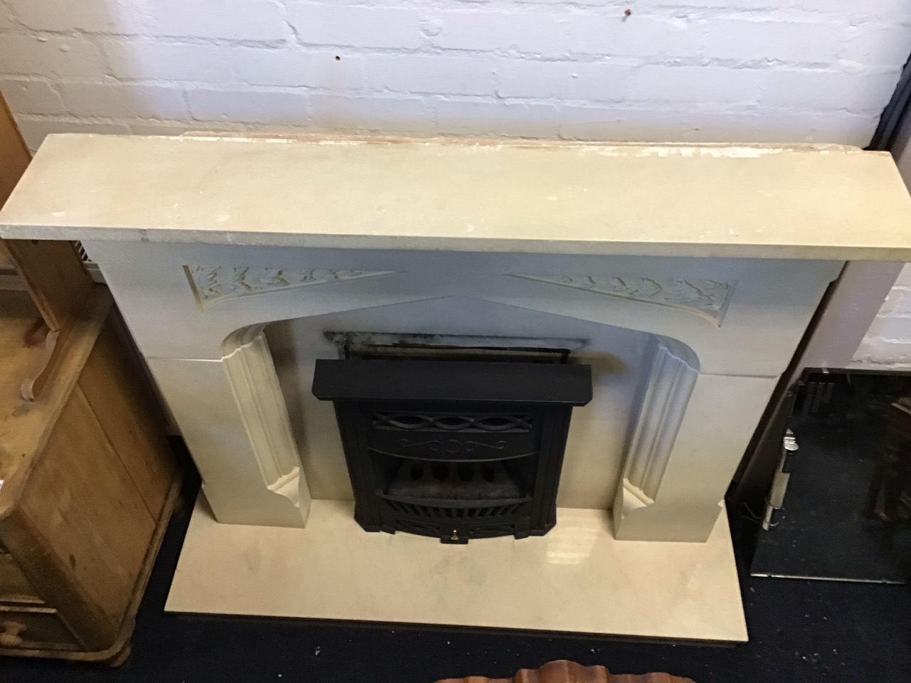 A faux limestone chimneypiece with rectangular mantlelshelf above a gothic shaped moulded aperture - Image 2 of 3