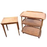 An Ercol elm three-tier trolley with rounded rectangular shelves on spindle supports with