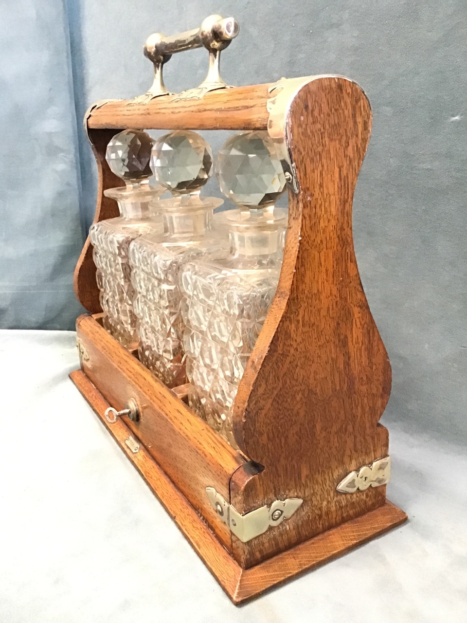 A late Victorian oak tantalus with silver plated mounts, the square cut glass decanters with ball - Image 3 of 3