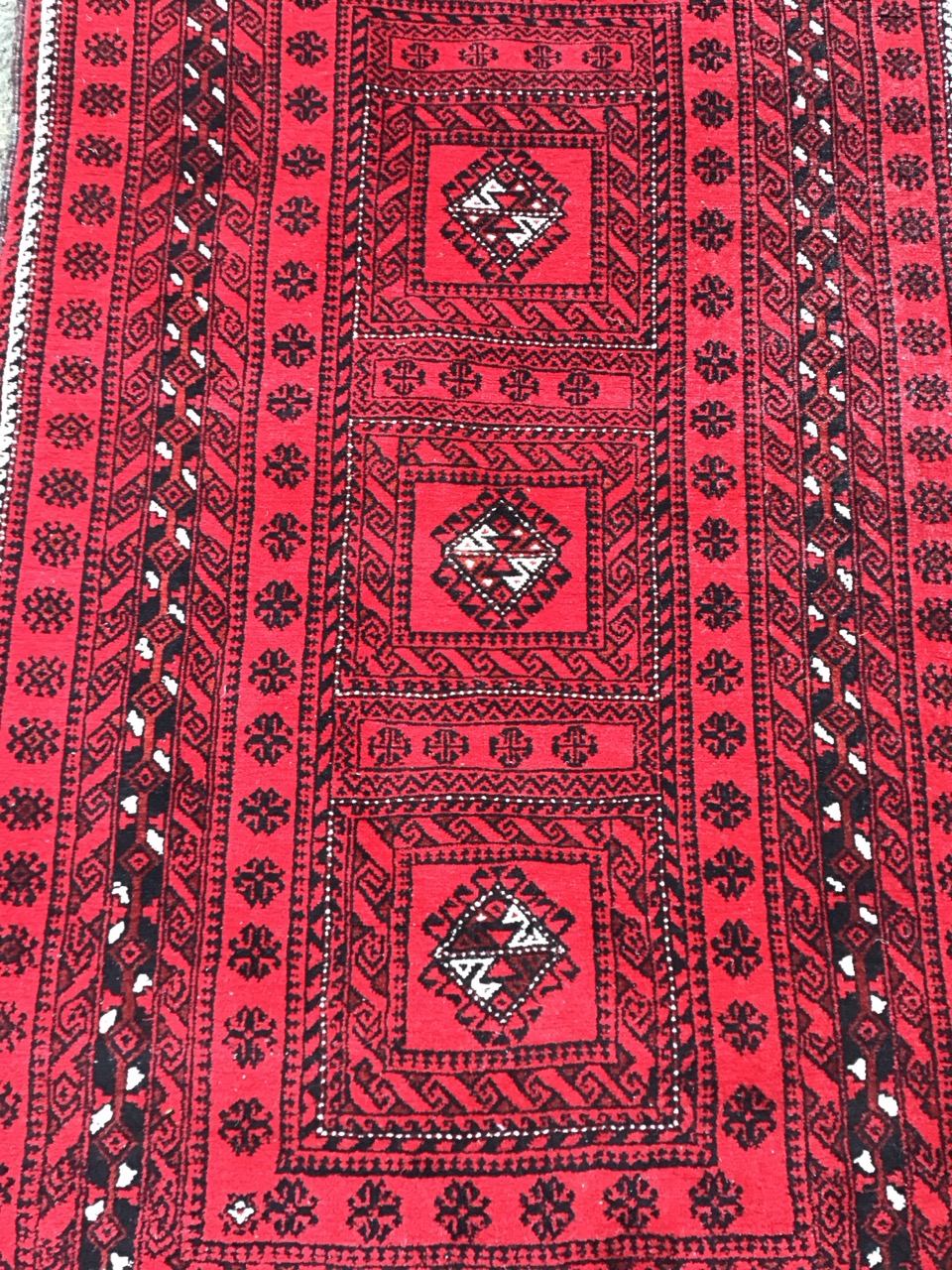 A Nahzat camel hair rug with three hooked medallions on a red ground within multiple flowerhead - Image 2 of 3
