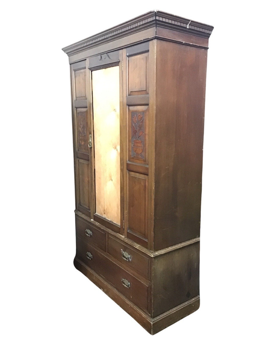 A late Victorian mahogany wardrobe, the dentil cornice above a central door flanked by carved