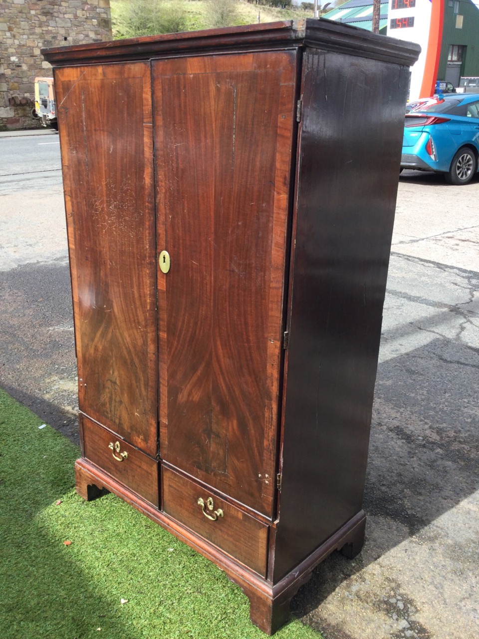 A Georgian walnut press cupboard with crossbanded doors enclosing a fitted interior with oak tray - Image 3 of 3