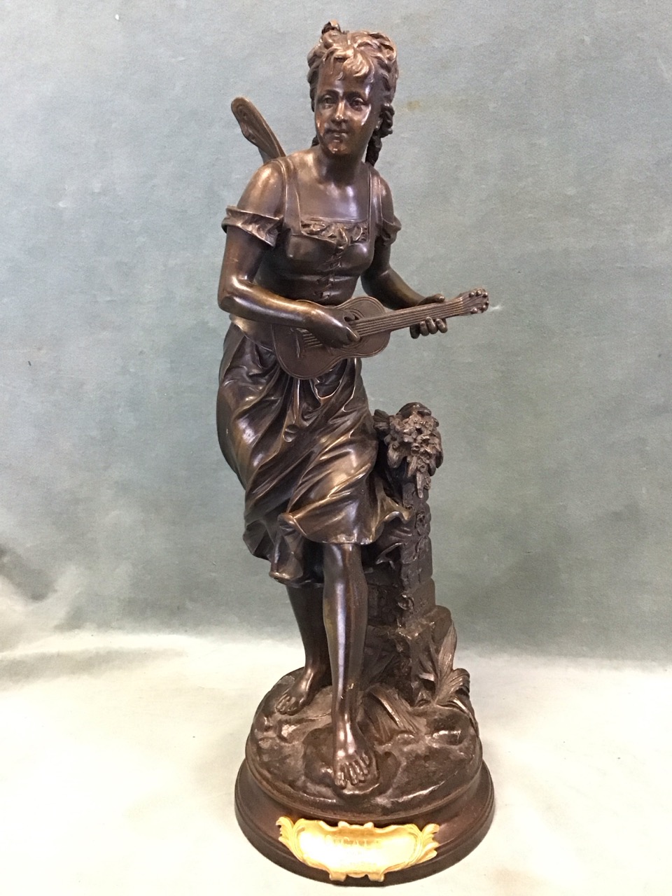 Eutrope Bouret, a C19th French patinated bronze figure of a winged fairy beside a plinth