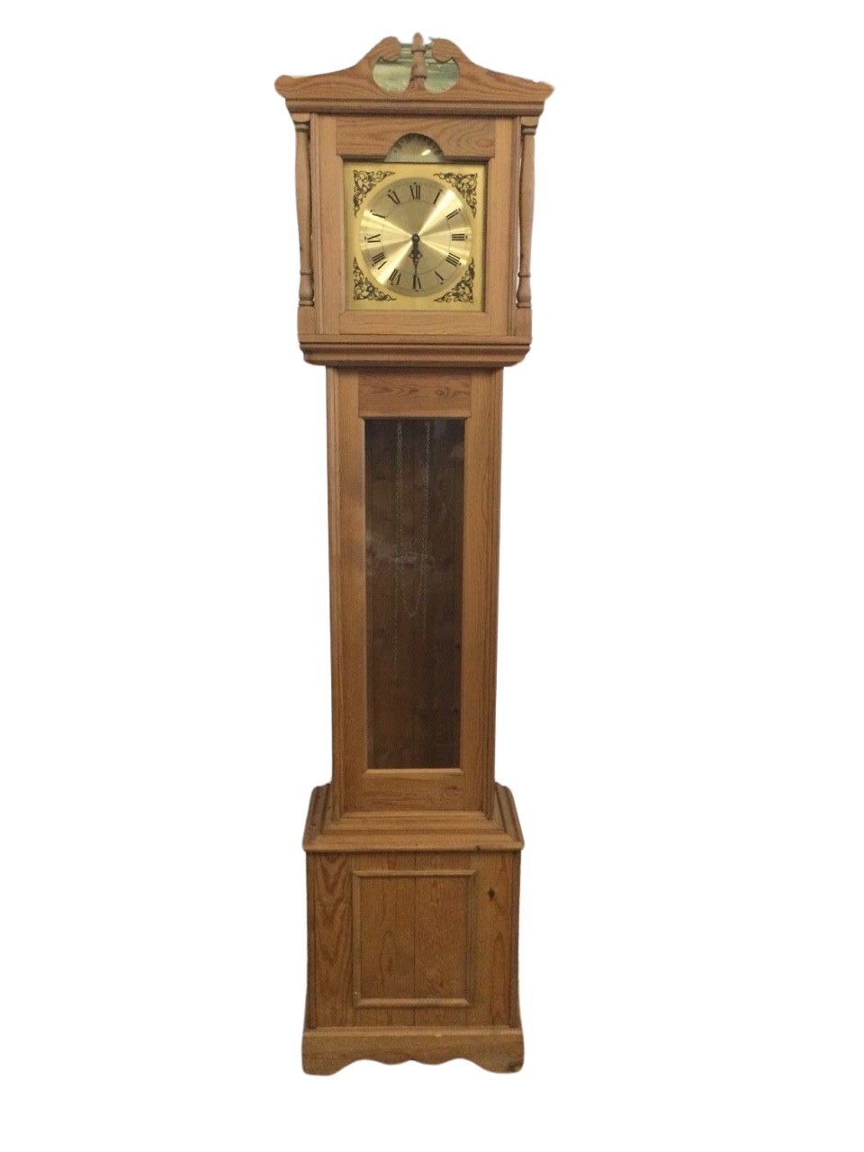 A Georgian style pine longcase clock with swan-neck pediment above glazed panel flanked by turned