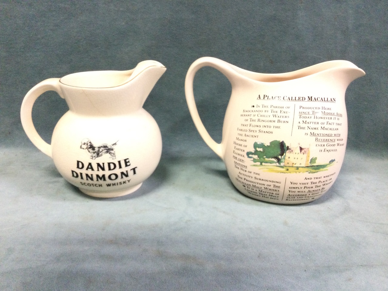 A Wade whisky water jug with Dandie Dinmont decoration and gilt rims; and a MacAllan whisky jug. (