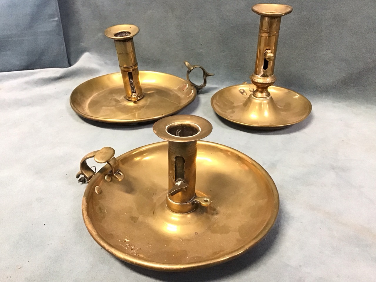 A pair of Georgian brass columnar candlesticks on flared square bases - 5.25in; and three nineteenth - Image 3 of 3
