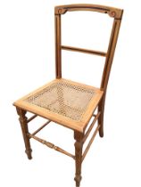 A Victorian aesthetic cane seated chair, the back with ebonised banding, supported on square