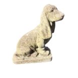 A composition stone basset hound, the animal seated on plinth. (20in)