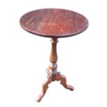 A circular Victorian mahogany occasional table supported on baluster turned column above scroll