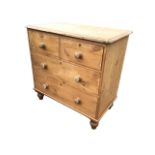 A Victorian pine chest with rectangular rounded top above two short and two long knobbed drawers,