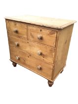 A Victorian pine chest with rectangular rounded top above two short and two long knobbed drawers,