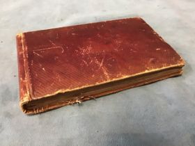 A Victorian leatherbound album with brass catch containing numerous pressed & named seaweed