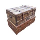An Edwardian canvas covered trunk with hardwood batten brass studded mounts and leather straps;