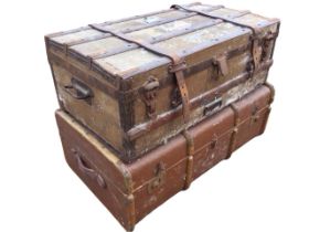 An Edwardian canvas covered trunk with hardwood batten brass studded mounts and leather straps;