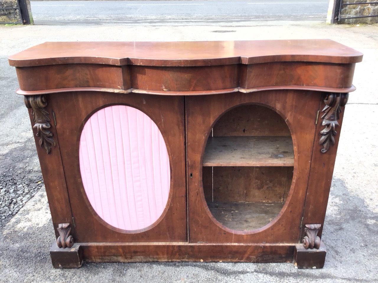 A Victorian mahogany side cabinet, the serpentine top and conforming frieze above a pair of oval - Image 2 of 3