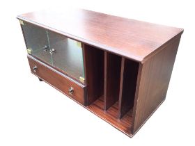 A contemporary mahogany cabinet with moulded top above glass doors, three-division compartment and