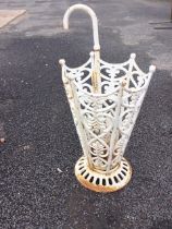 A painted cast iron stickstand in the form of an umbrella with pierced foliate scrolled panels on
