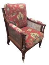 A Gillows style regency mahogany bergere library armchair with rectangular moulded caned back and