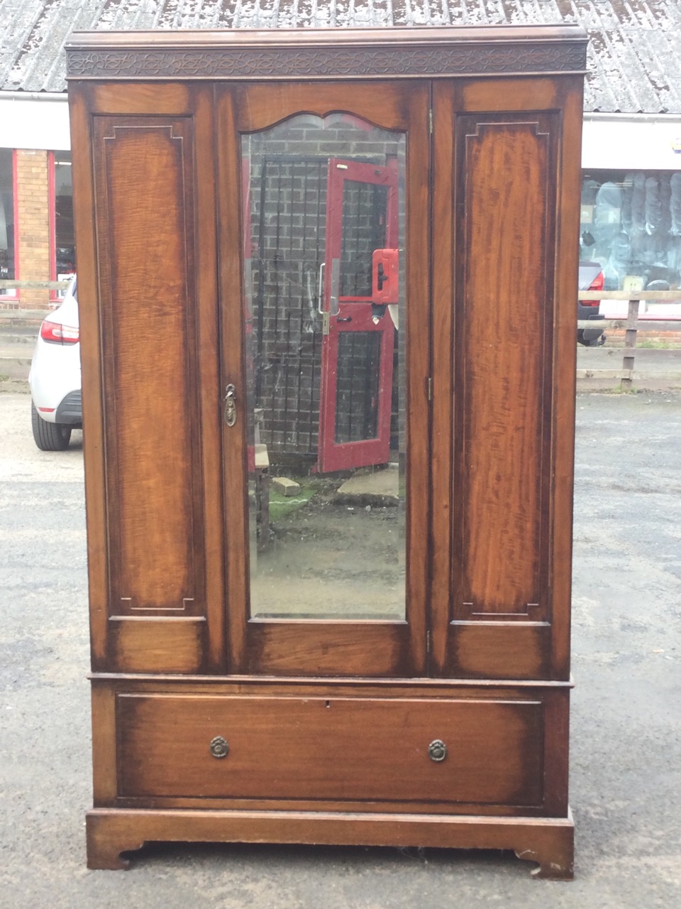 An Edwardian mahogany wardrobe with moulded blind fretwork frieze above a central bevelled - Image 2 of 3