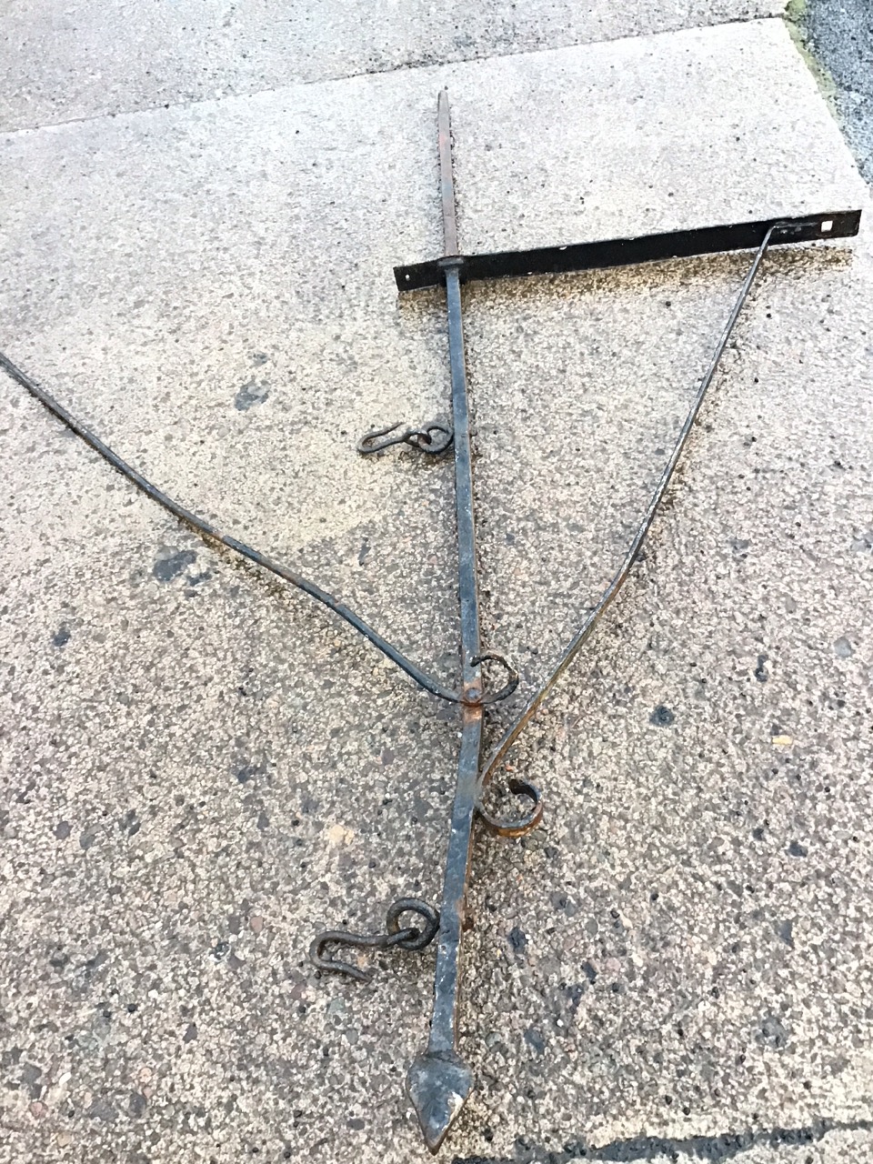 A Victorian wrought iron hanging sign bracket, the square bar with spear terminal suspending twin - Image 2 of 3