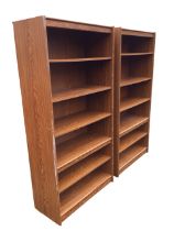 A pair of contemporary oak faced open bookcases, each with adjustable deep shelves. (35.75in x 15.
