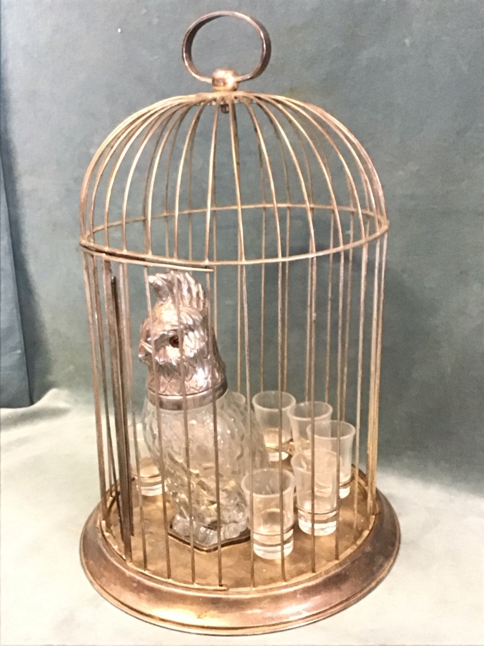 A 30s novelty cocktail set in the form of a circular domed birdcage with a mould-blown glass