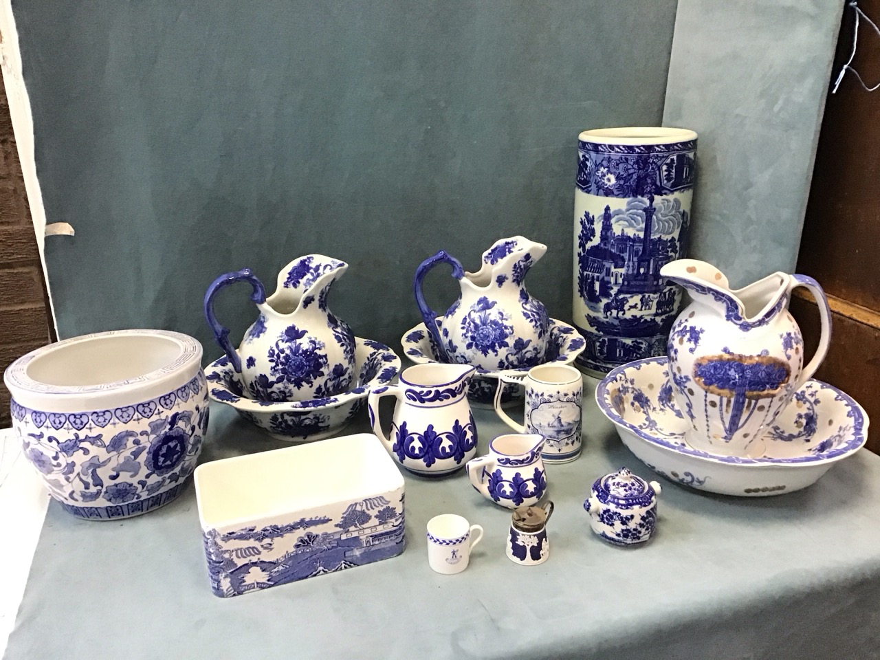 A collection of blue & white ceramics - three jug & basin sets, a Maling willow pattern trough, a