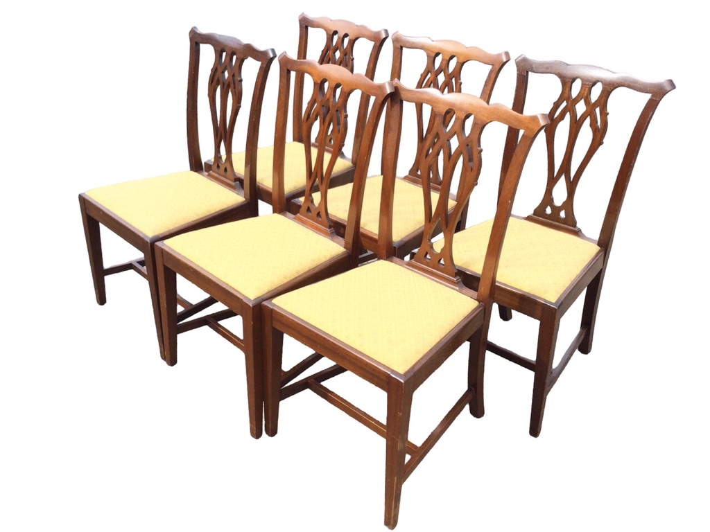 A set of six mahogany Chippendale style dining chairs with waved backs and pierced splats above
