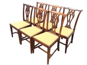 A set of six mahogany Chippendale style dining chairs with waved backs and pierced splats above
