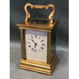 A gilt brass gorge cased repeating carriage clock, with bevelled glass panels and enamelled dial