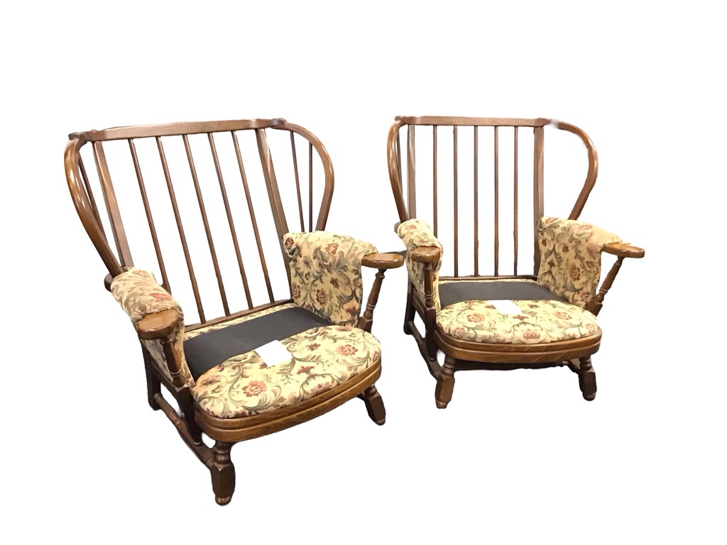 A pair of stained beech armchairs, the hooped spindle backs with loose button upholstered