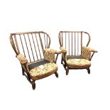 A pair of stained beech armchairs, the hooped spindle backs with loose button upholstered