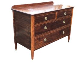 An Edwardian mahogany chest having two short and two long ebony & boxwood strung drawers with