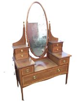 A Victorian mahogany satinwood banded dressing table, with oval bevelled mirror on columns with